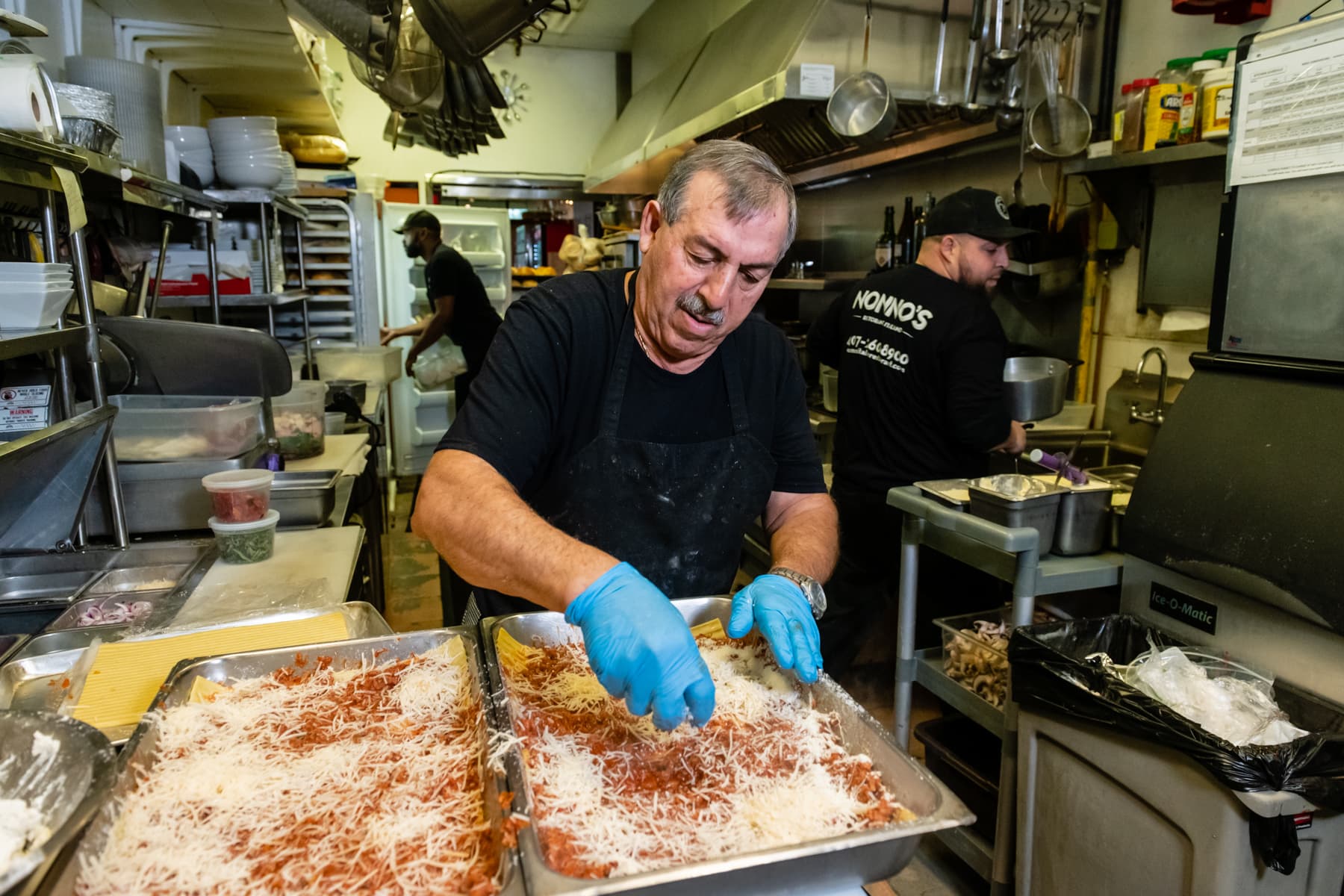 Stefano preparing trays of lasagna in the Nonno's kitchen