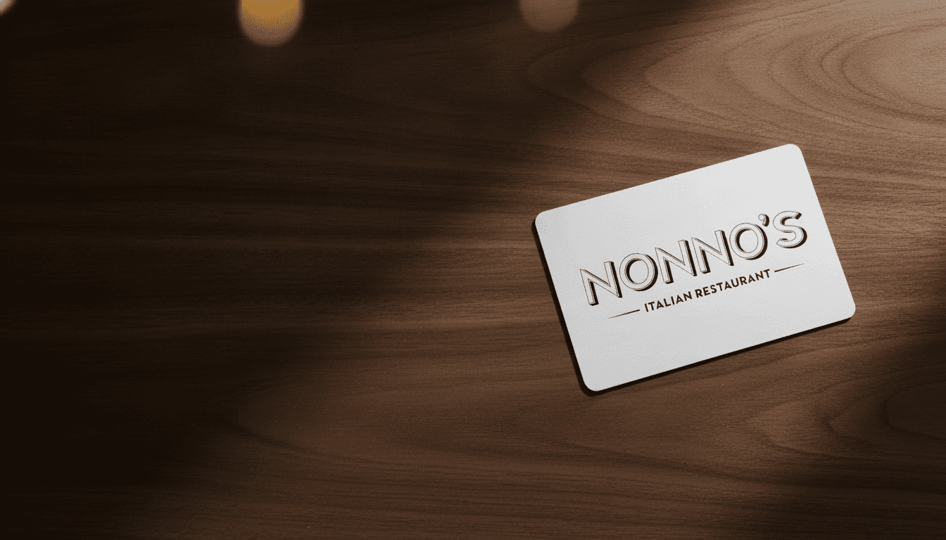 A physical Nonno's gift card resting on a dark wood table